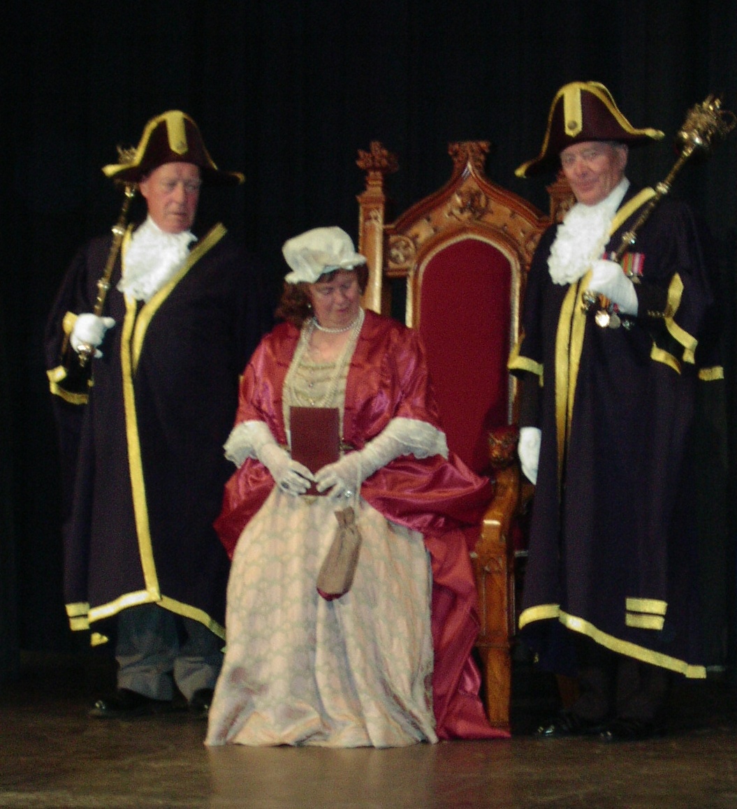 JPEG image - (13) � Queen Anne on her throne (played by Muriel Mudie), flanked by Michael King and Victor Jones, the Glastonbury macebearers. ...